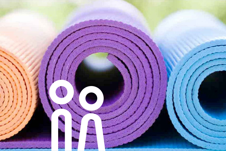 Rolled-up yoga mats in different colours.